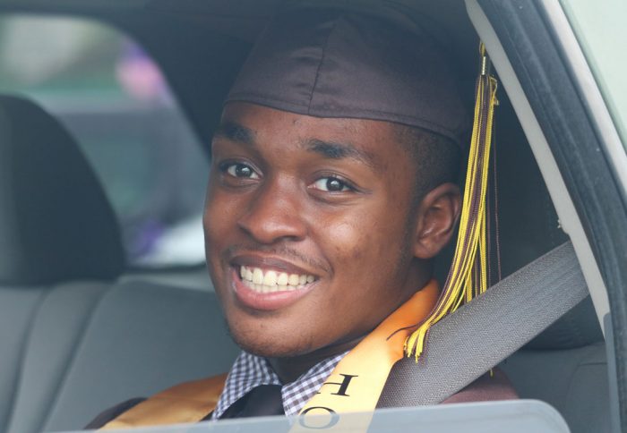 High School Student Graduation in car with Graduation Cap