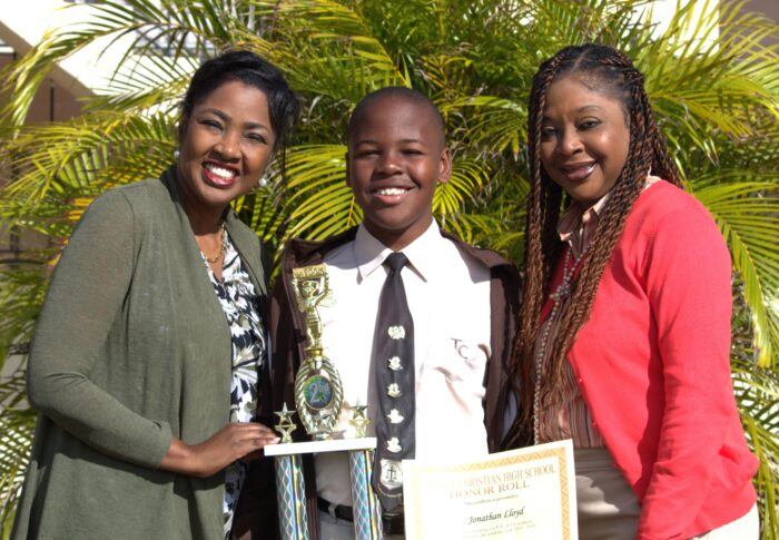 Jonathan Lloyd pictured alongside his mother (left) and coach (right).